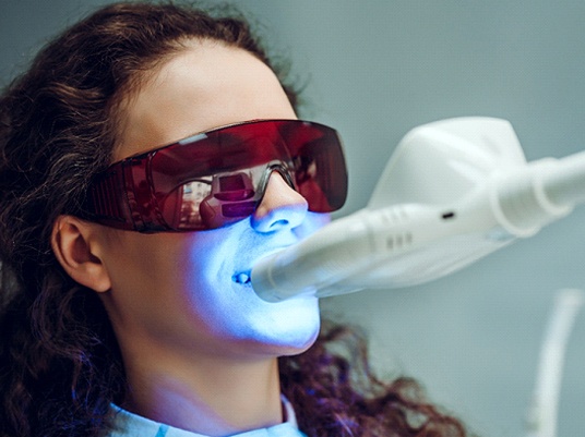 Woman during in-office teeth whitening treatment.