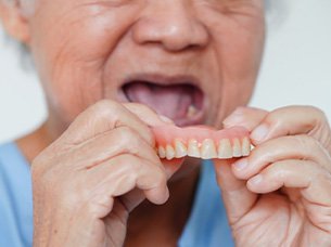 Man removing his dentures